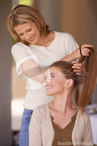 Image of Women, mother and daughter in home, hairdresser or happy for helping hand, conversation and family home. People, girl and mature mom with hair care, talking and smile with love, connection or bonding