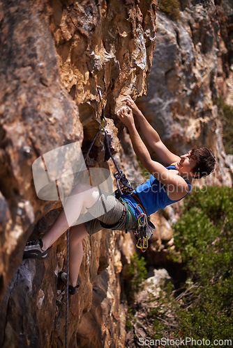 Image of Rock climbing, woman and fitness with rope, travel and gear to explore in nature on a mountain. Cliff, hiking and sport with athlete and adventure for workout, exercise and climber training outdoor