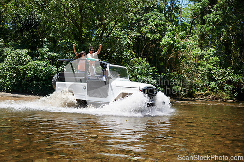 Image of Couple, forest and adventure with 4x4, river and outdoor with love, care or nature with drive in summer. People, man and woman for splash in vehicle, car or journey on road trip in jungle in Colombia