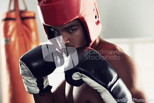 Image of Sports, portrait and man boxer in gym for exercise, workout and combat training for competition. Breathing, health and shirtless male athlete fighter in boxing ring with gloves in fitness center.