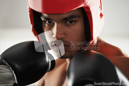 Image of Fitness, cardio and man boxer in gym for exercise, workout and combat training for competition. Breathing, health and shirtless male athlete fighter in boxing ring with gloves in sports center.