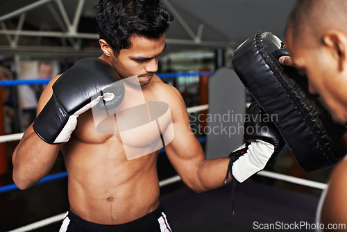 Image of Fitness, sports and fighter in gym with coach for training, self defense or combat training. Exercise, workout or boxing with shirtless man and personal trainer in preparation for competition