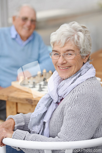 Image of Chess, game and happy portrait with old people together in retirement to relax with happiness. Elderly, man and woman outdoor with a smile for winning competition, checkmate or activity with strategy