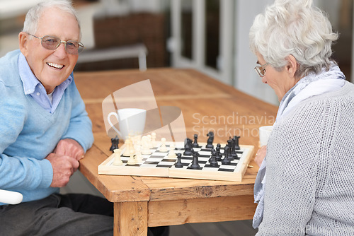 Image of Happy, game and senior couple with chess together in retirement to relax on holiday or vacation. Elderly, man and woman outdoor with smile for winning competition, checkmate or activity with strategy