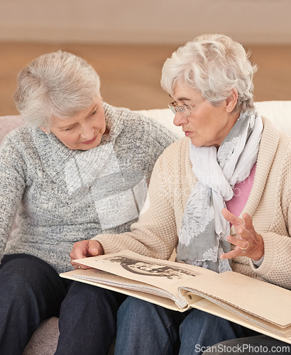 Image of Elderly women, photo album and memory nostalgia in retirement or together, photograph or connection. Old people, photography and picture book in apartment for remember past, bonding or conversation