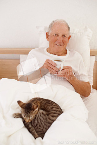 Image of Senior man, coffee and portrait in bed, smile and relaxing in retirement at home. Elderly male person, bedroom and happy in apartment, cat and hot beverage for peace or calming drink on weekend