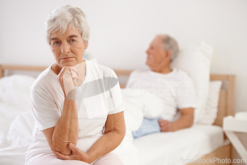 Image of Senior, couple and sad in bedroom with conflict, ignore and crisis in marriage for mental health or retirement. Elderly, woman or man with fight, argument or divorce on bed in home with disagreement