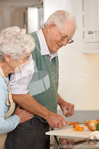 Image of Senior couple, cutting vegetables and embrace in kitchen, food preparation and love at home. Elderly people, healthy meal and organic ingredients for nutrition, hug and diet for detox in retirement