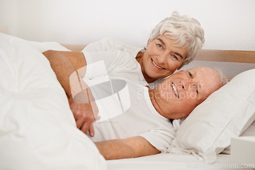 Image of Senior couple, portrait and relaxing in bed, smiling and love in retirement for bonding on weekend. Elderly people, bedroom and resting or happy in marriage, romance and morning routine at home