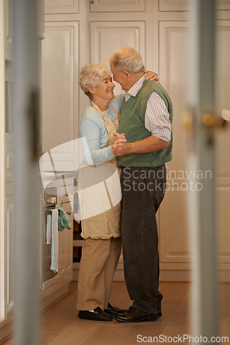 Image of Elderly, couple and happy with dancing in kitchen for bonding, support and holding hands with romance. Senior, man and woman with hug, embrace and smile for relationship, dancer and love in home