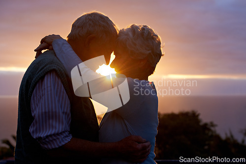 Image of Sunset, senior couple and embrace outdoor, care and bonding for connection together in nature. Man, woman and touch forehead for love, romance and hug for commitment to relationship in retirement