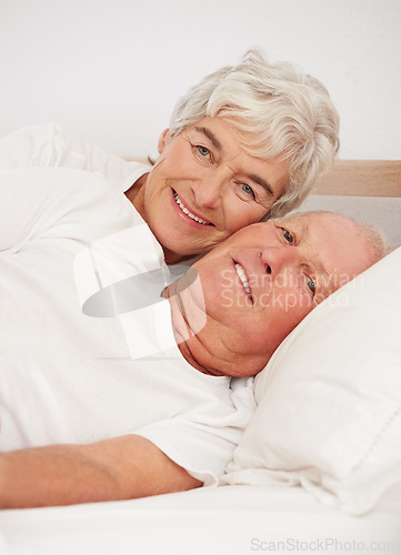 Image of Senior couple, portrait and together in bed, relaxing and love in retirement for bonding on weekend. Elderly people, bedroom and resting or happy in marriage, romance and morning routine at home