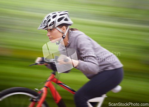 Image of Woman, bike and nature with ride, speed and fitness for health and wellness or workout. Athlete, cycling and exercise for training, transportation and adventure with helmet for cardio and motion blur