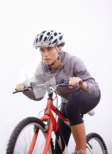 Image of Athlete, bike and nature with ride, speed and fitness for health and wellness or workout. Woman, cycling and exercise for training, transportation and adventure with helmet and cardio or perseverance