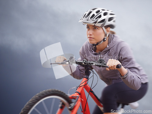 Image of Woman, bike and nature with cycling, speed and fitness for health and wellness or workout. Athlete, ride and exercise for training, transportation and adventure with helmet and cardio or confidence