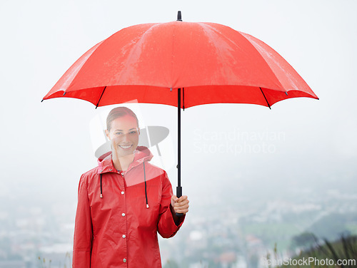 Image of Woman, portrait and umbrella for security, outdoor nature and protection from rain in weather. Female person, insurance and safety or shield from storm, winter and travel to Scotland for holiday