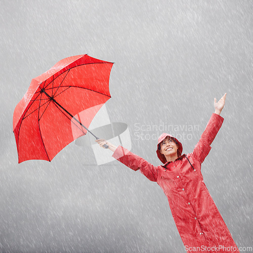 Image of Woman, rainfall and umbrella for protection, outdoor nature and security from rain in weather. Female person, insurance and safety or shield from storm, winter and travel for holiday or vacation