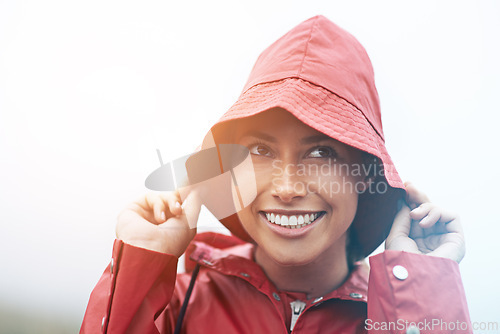 Image of Woman, happy and raincoat for protection, outdoor nature and waterproof jacket for weather or overcast. Female person, smile and safety or shield from cold, winter and travel to Scotland for holiday