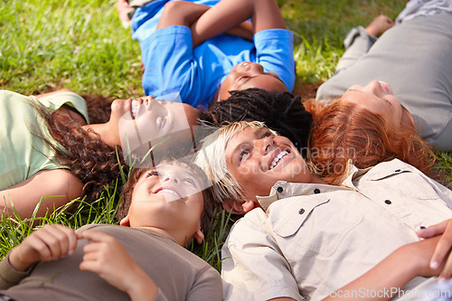 Image of Kids on grass, summer and relax with happiness, smile and weekend break with youth and peaceful. Children, boys and girls in a park and excited with games and looking up with nature, joy or diversity