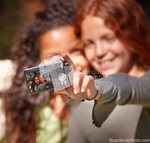 Image of Happy girl, friends and selfie with camera in nature for memory or outdoor photography together. Young female person, child or kid with smile for picture, photo or social media in relax or friendship