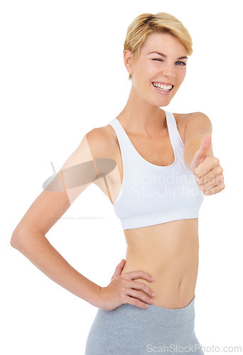 Image of Portrait, wink and woman with thumbs up for fitness with emoji isolated on a white studio background. Smile, sport and person with like hand gesture for success, exercise and workout for healthy body