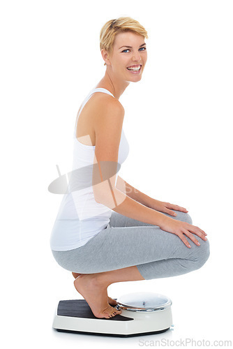 Image of Woman, portrait and on scale in studio for weight loss, healthcare and wellness for vitality. Female person, diet and check calories for slim body for self care and happy on a white background