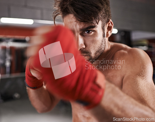 Image of Man, fist and ready for fighting in gym, fitness and topless for exercise and workout. Male person, bodybuilder and punching for challenge or practice, training and martial arts for competition