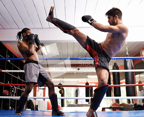 Image of Kickboxing, fight and men training for exercise and sport in gym, coach and athlete with workout and action. Energy, challenge and MMA with athlete together in ring for boxing, fitness and endurance