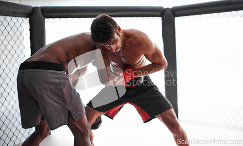 Image of Fight, wrestling and men sparring in cage for kickboxing competition, challenge and fitness with sports in gym. Match, strong fighter and resilience in exercise, practice and power in battle together