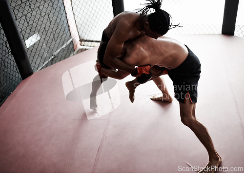 Image of Fight, wrestling and men in cage for kickboxing competition, challenge and fitness with sports in gym. Match, strong fighter and resilience in exercise, sparring practice and power in battle together