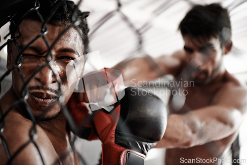 Image of Punch, pain and men sparring in cage for kickboxing competition, challenge and fitness with fight in gym. Boxing match, strong fighter and knockout with exercise, practice or power in battle together