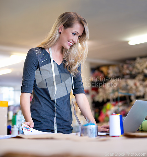 Image of Business, woman and designer with laptop for fashion, fabric research or web design concept at work. Creative, person or happy tailor with technology for online pattern, inspiration or sewing textile