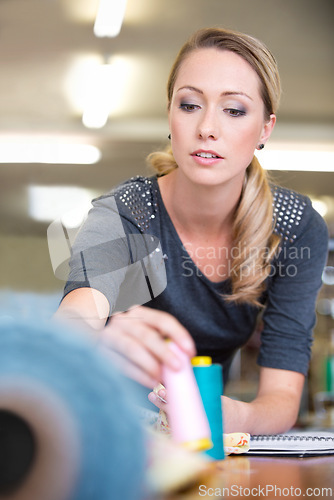 Image of Business, woman and designer with textile for fashion with fabric check and sewing equipment at work. Creative, person and tailor or seamstress with thread for pattern, inspiration and design studio