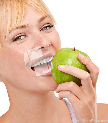 Image of Portrait, nutrition and happy woman with apple for diet, benefits or food to lose weight in studio. Healthy eating, smile and face of girl with fruit for body wellness, digestion and white background