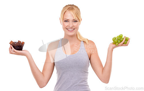 Image of Portrait, smile and woman with choice of fruit, chocolate or healthy eating food to lose weight in studio. Happy, face and girl with apple vs candy, decision for diet or nutrition on white background