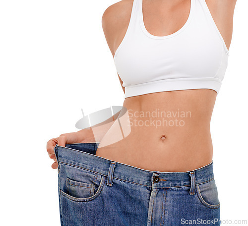 Image of Jeans, stomach and woman in studio with weight loss for health benefits, diet and fitness goals. Female person, pants and body transformation on white background for progress, results and comparison