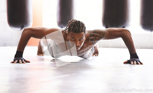 Image of Portrait, fitness and push up with black man on floor of gym for training strong muscles or power. Exercise, health and body with confident young athlete in workout to improve physical wellness