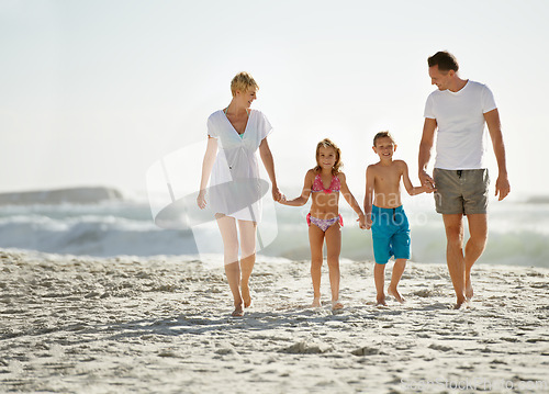 Image of Parents, children and hand holding on beach for love connection with tropical travel, holiday or outdoor. Man, woman and siblings or walking on sand in Florida for vacation relax, seaside or family