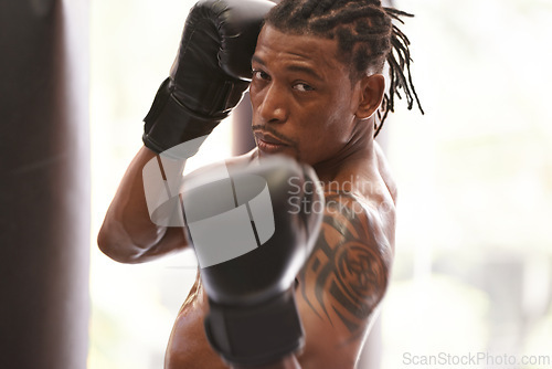 Image of Fitness, portrait and black man with boxing gloves in gym for challenge, fight and competition training. Power, muscle and serious face of champion boxer at workout with confidence in sports club.