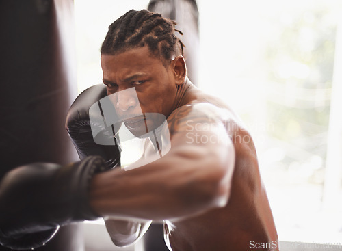 Image of Battle, portrait and black man with boxing gloves in gym for challenge, fight and competition training. Power, muscle and serious face of champion boxer at workout with confidence in sports club.