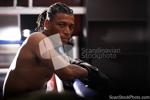 Image of Portrait, fitness and black man boxer in ring at gym for combat sports training or competition. Exercise, boxing or fighting with shirtless young athlete on break from intense self defense workout