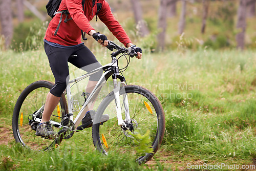 Image of Bike, wheels and person cycling in countryside for fitness, health or off road trail hobby outdoor. Exercise, sports or training with athlete or cyclist on bicycle in nature for cardio workout