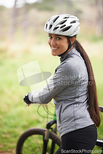 Image of Nature, cycling and portrait of woman with bicycle for fitness in an outdoor park training for race or marathon. Sport, exercise and female cyclist walking with bike for workout in field or forest.