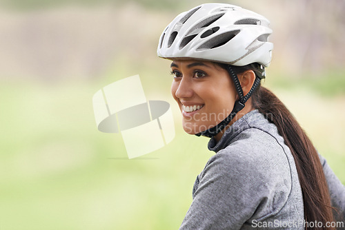 Image of Smile, cycling and woman in nature, thinking or dream on mockup space outdoor to exercise for fitness. Bicyclist, helmet and happy person travel on journey, adventure or workout for sports in summer