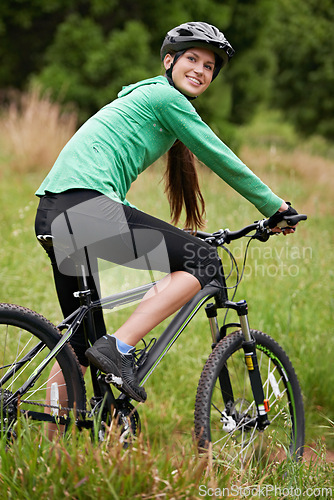 Image of Nature, portrait and woman athlete with bicycle for fitness in outdoor park training for race or marathon. Sport, exercise and female cyclist riding bike for cardio workout in field, woods or forest.