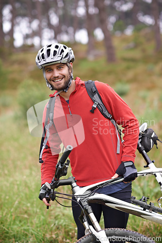 Image of Portrait, bike and man cycling in nature for adventure, discovery or off road sports hobby. Exercise, fitness and wellness with young cyclist on bicycle in countryside for cardio training or health