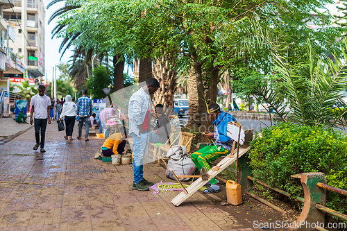 Image of Shoe cleaner on the street during Easter holiday, Bahir Dar, Ethiopia