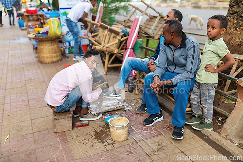 Image of Shoe cleaner on the street during Easter holiday, Bahir Dar, Ethiopia