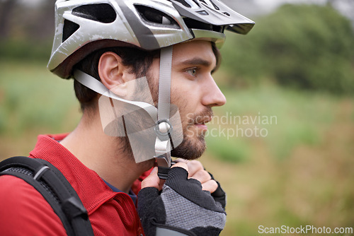 Image of Cycling, man and health with helmet for safety, protection and exercise gear to travel outdoor. Bicyclist, person and workout in preparation for training, sports or closeup for fitness in profile