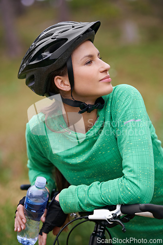 Image of Thinking, bicycle and woman in nature to exercise with water bottle outdoor for hydration. Bicyclist, cycling and female person on bike to travel on journey, adventure or workout for sports in summer